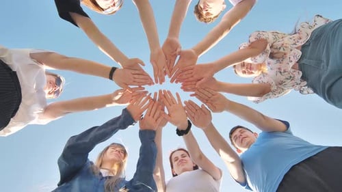 Youthful Team Arms Together in a Circle