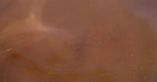 Shimmering Bronze Liquid with Gold Glitter Particles