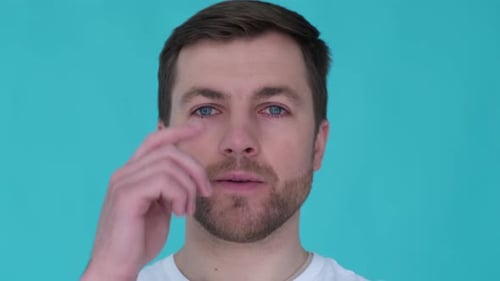 Head of an Attractive Guy Close Up on a Blue Background