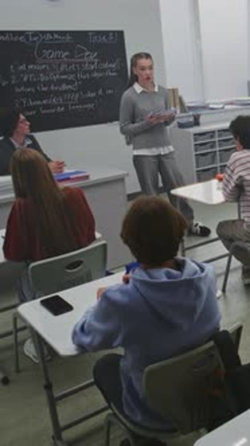 Teen Presenting to Classmates in Classroom Setting
