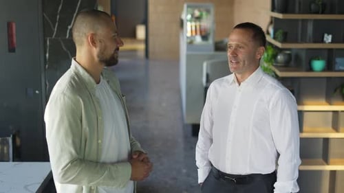 Businessmen Talking in Modern Airy Office Space