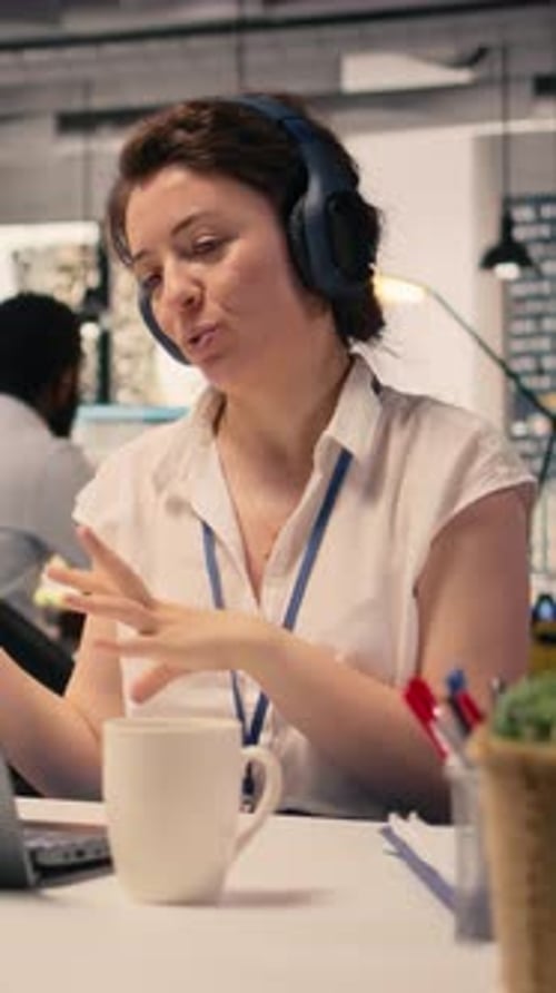Woman in Headset Speaking in Modern Office Setting