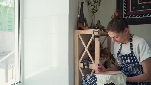 Woman Crafts Pottery Inside a Home Studio