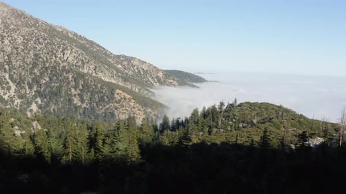 Aerial View Above Sea of Clouds, Temperate Mountain Range, Flying Down Into Shadow