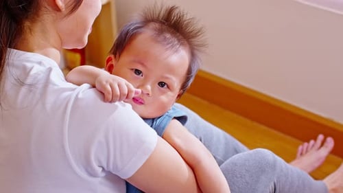 Close up asian baby smilingand laughing with her mother at warmth place. Asian mom talking and playi