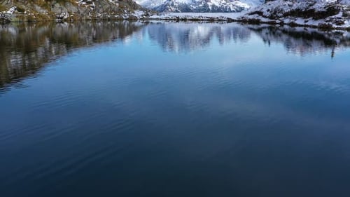 Mountain Lake in Dolomies mountains. Clear mountain water reflecting the snowy peaks of the mountain