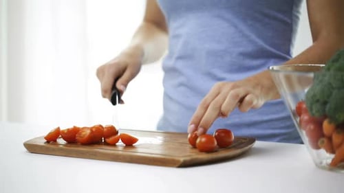 Woman Cutting Fresh Cherry Tomatoes in Bright Kitchen