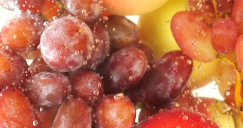 Background with fruits and berries in water with air bubbles.
