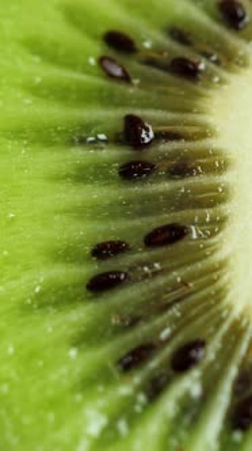 A Lot of Sliced Kiwi Rotating Ripe Tropical Fruits Closeup Vertical