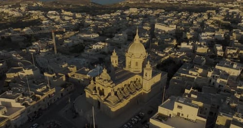 Aerial view of church and town with historic architecture, Malta.