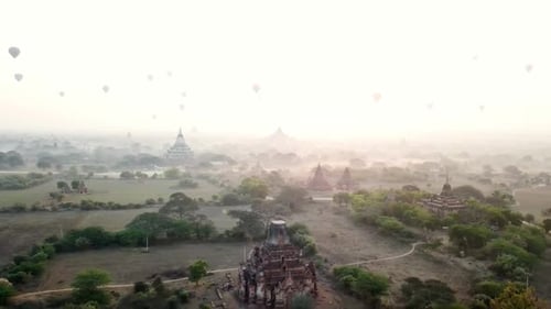 Hot air balloons flying over bagan temples at sunrise in myanmar