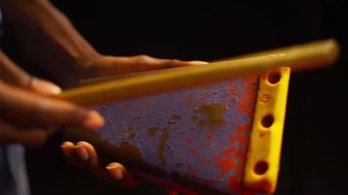 Cow Bell being Played as a percussion instrument by hitting it with a drum stick
