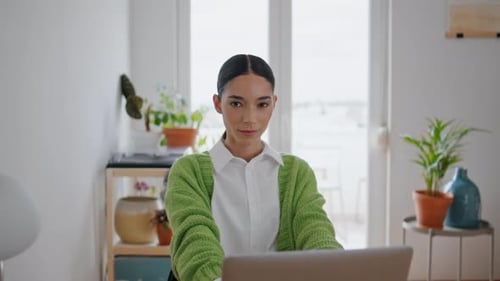 Woman Working on Laptop at Desk at Home