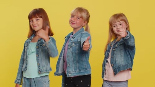 Girls Giving Thumbs-Up in Denim Jackets