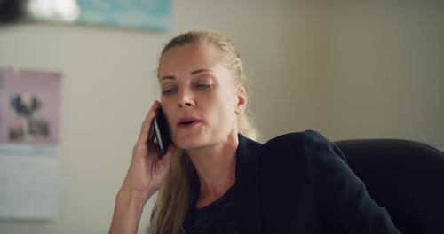 Blonde Business Woman Talks On Mobile Phone In Office During The Daytime. Medium To Closeup Shot ...