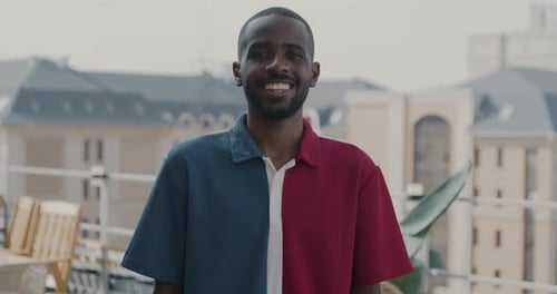 Slow Motion Portrait of Attractive African American Man Standing on Rooftop in City Smiling Looking