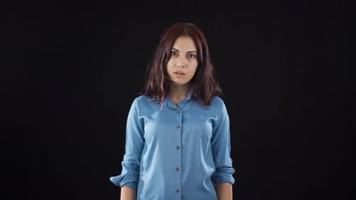 Psychologically troubled woman looking strangely at camera.