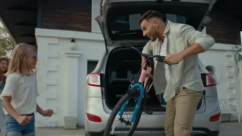 Family Unloading Bicycles from Car for a Ride