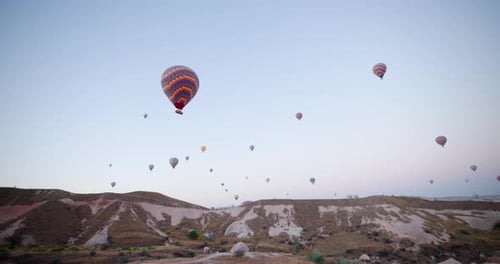 Vibrant Hot Air Balloons Soaring Over the Unique Rock Formations of Cappadocia, Turkey