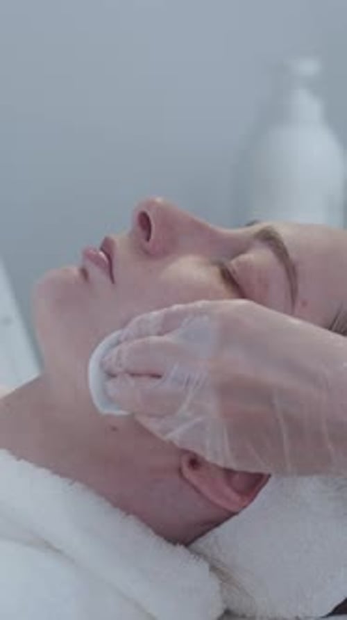 Cosmetology Treatment the Master Wipes the Client's Skin with