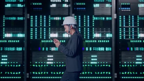 Asian Businesswoman Use Tablet While Walking in Data Center
