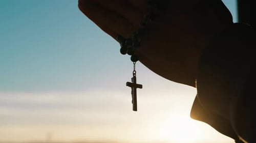 Silhouette of Praying Hands with Christian Crucifix