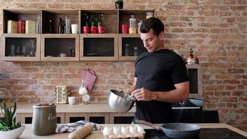 Man Whisking Ingredients in Sunny Kitchen