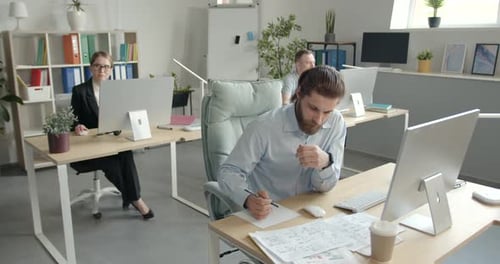 Focused Employee Sitting at Workplace in the Office