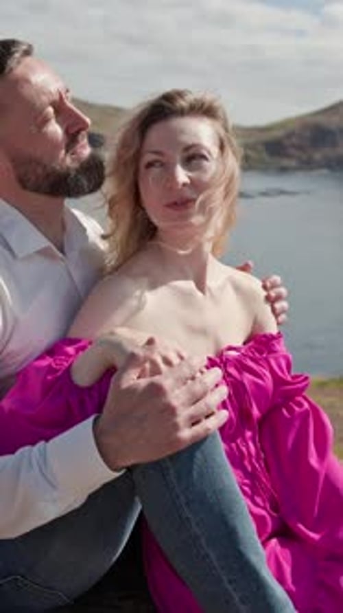 Couple Embracing on Cliff Overlooking Tranquil Ocean in Madeira