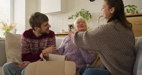 Family Reminiscing Looking at Photos on Couch