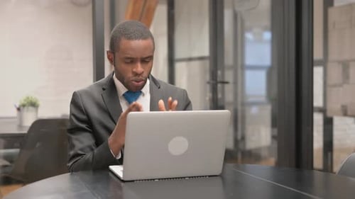 Businessman Talking on Video Conference in Modern Office
