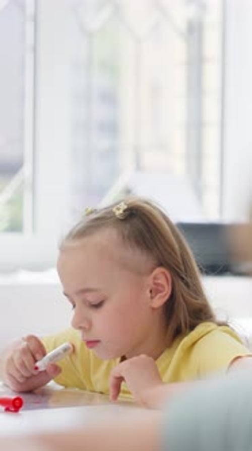 Young Girl Drawing at a Sunlit Table