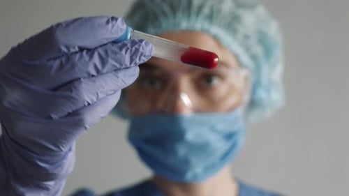 Medical Professional Examining Blood Sample in Test Tube