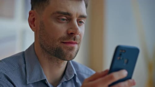 Man Using Smartphone Indoors Close Up
