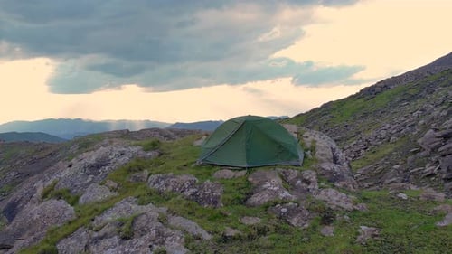 Aerial Sunset Over Mountains in Swiss Alps with Tourist Tent