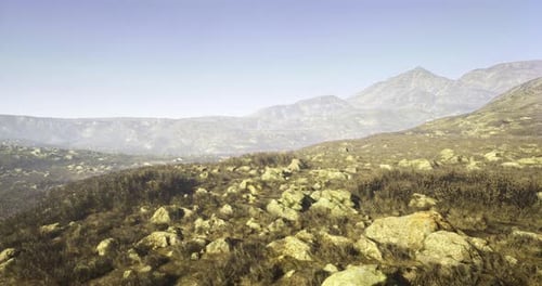 Stunning Natural Landscape with Rocky Terrain and Distant Mountains in Daylight