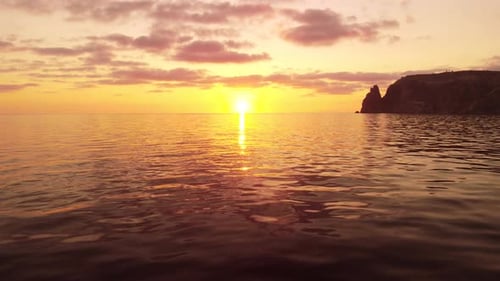 Aerial View on Sunset Over Calm Sea and Volcanic Rocky Shores