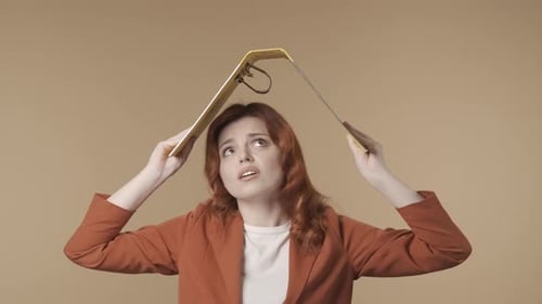 Worried Woman with Binder Overhead in Mid Shot