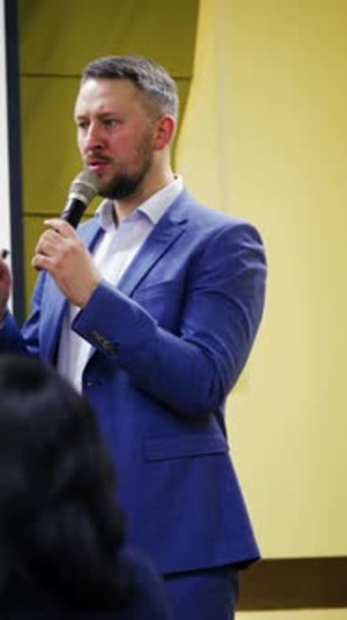 Experienced speaker talking into a microphone.