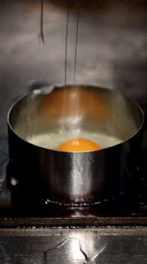 Egg Cooks in Circular Mold on Countertop
