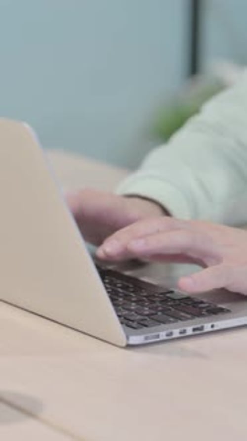Close up of Hands Typing on Laptop, vertical video