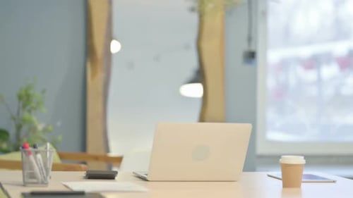 Senior Man Arriving At Desk and Typing on Laptop