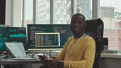 Portrait of African American Programmer Coding in Office