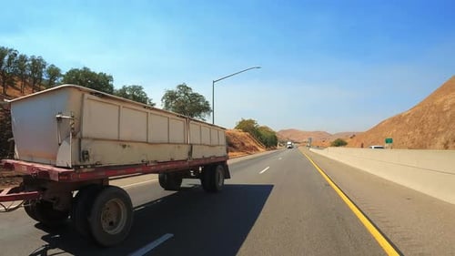 Passing a double trailer freightliner truck on a highway in slow motion