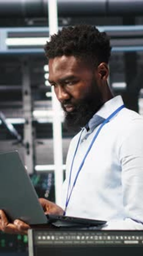 Vertical Video Happy Data Center Admin Uses Node Tree Programming on Laptop