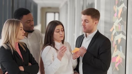 young business team cross out tasks completed