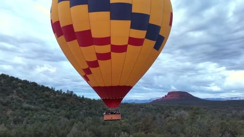 Hot Air Balloon Flying Over Beautiful Landscape Of Sedona In Arizona At Sunrise - drone shot