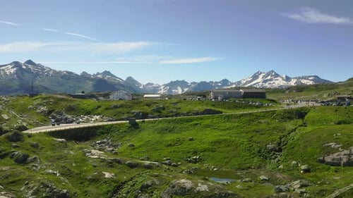 Slow aerial ascent over Grimsel pass in Switzerland, revealing a beautiful lake with an amazing view