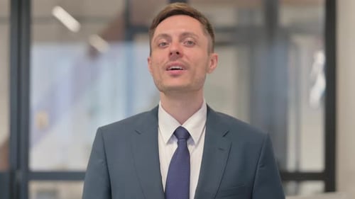 Smiling Businessman in Office Setting Portrait
