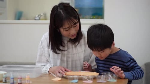 Woman and Child Painting Together at Home